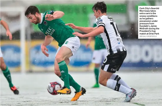  ?? SEB DALY/SPORTSFILE ?? Cork City’s Gearóid Morrissey takes extra care in the snowy conditions as he gathers possession under pressure from Dundalk’s Jamie McGrath during the President’s Cup match at Oriel Park