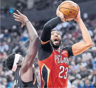  ?? NATHAN DENETTE THE CANADIAN PRESS ?? New Orleans Pelicans forward Anthony Davis shoots over Raptors forward Pascal Siakam on Monday at Scotiabank Arena. Siakam had 22 points in a losing effort as the Raptors dropped their first home game of the season, 126-110. More,