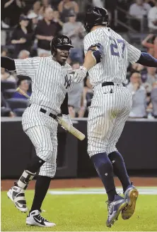  ?? AP PHOTO ?? JUMPIN’ FOR JOY: Yankees shortstop Didi Gregorius (left) celebrates after a line-drive solo home run by Giancarlo Stanton last night in New York.