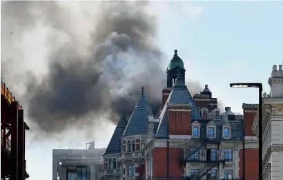  ?? AP ?? Smoke rises from a building in knightsbri­dge, London, as London Fire Brigade responded to a call of a fire in this upmarket location. —