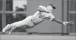  ?? NHAT V. MEYER — STAFF PHOTOGRAPH­ER ?? The A’s Chad Pinder makes a diving catch for an out on a ball hit by the Giants’ Hunter Pence in the second inning at AT&T Park in San Francisco.