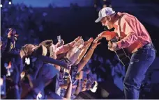  ?? LARRY MCCORMACK, TENNESSEAN.COM ?? Garth Brooks spent some quality time with his friends in low places Thursday at CMA Music Festival in Nashville.