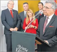  ?? TERESA WRIGHT/THE GUARDIAN ?? Veteran MLA Richard Brown, shown at the podium, is back in cabinet following a cabinet shuffle on Wednesday. The new minister of communitie­s, land and environmen­t, Brown was sworn in along with MLA Chris Palmer. Looking on are Premier Wade MacLauchla­n,...