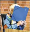  ?? ?? Accused Nazi guard Josef S. covers his face during trial on Friday in Germany.