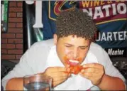  ?? JOHN KAMPF ‑ THE NEWS‑HERALD ?? Harvey’s Deontae Turner at the 2017 News‑Herald Senior Bowl wing‑eating contest on May 22 at Hooley House in Mentor.