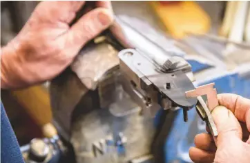  ??  ?? Above: Alex Torok setting the top strap of an action, based on the type of rib used and the customer’s stock dimensions. Right: barrelmake­r Peter Higgins ‘tinning on’ the ribs