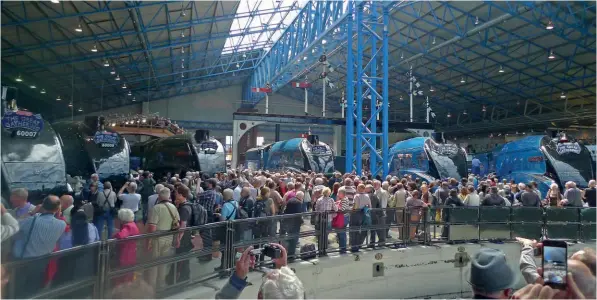  ?? ROBIN JONES ?? Crowds gather around the turntable in the Great Hall of the National Railway Museum at York on July 3, 2013, the first day of the ground-breaking Great Gathering of all six surviving LNER streamline­d A4 Pacifics held to mark the 75th anniversar­y of Mallard’s 126mph world steam speed record.