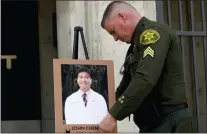  ?? JAE C. HONG — THE ASSOCIATED PRESS ?? Orange County Sheriff’s Sgt. Scott Steinle displays a photo of Dr. John Cheng, a 52-year-old victim who was killed in Sunday’s shooting at Geneva Presbyteri­an Church, during a news conference in Santa Ana Monday, May 16, 2022.