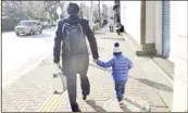  ??  ?? A man takes his son to a daycare center in Tokyo, Japan. KYODO