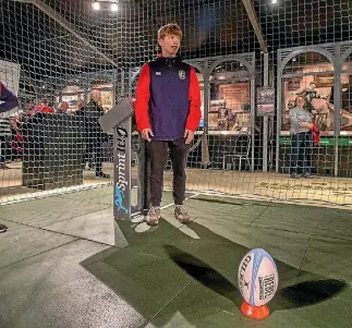  ?? PHOTO: MURRAY WILSON/ FAIRFAX NZ ?? Lions rugby supporter Charlie Worth gives the New Zealand Rugby Museum goal-kicking tee a try.