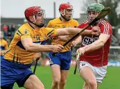  ??  ?? Pushing for glory: Clare’s Peter Duggan (left) and Darren Browne of Cork clash in their League meeting this spring