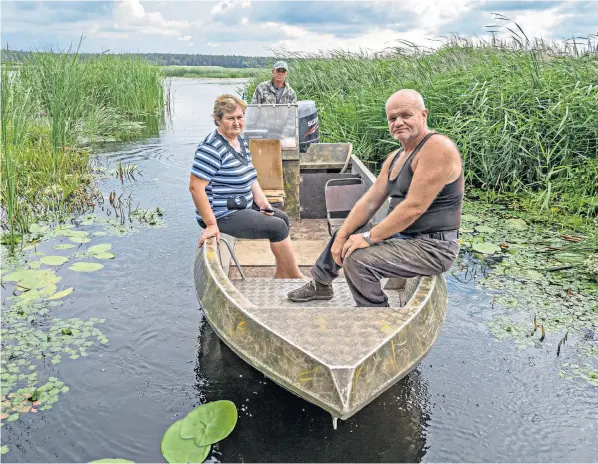  ?? ?? Oleksandr Dvorianets at the wheel of his boat with Andrii Bushuiev and Olena Aliieva