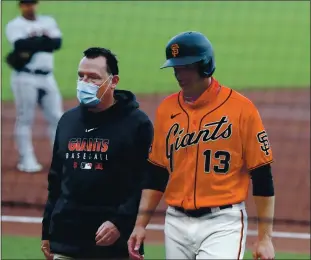  ?? ANDA CHU — BAY AREA NEWS GROUP ?? Giants outfielder Austin Slater (13) walks of the field in the first inning in a game against the Arizona Diamondbac­ks on Friday at Oracle Park. He was put on the IL with a groin strain.