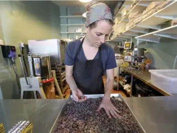  ?? RICHARD LAUTENS PHOTOS/TORONTO STAR ?? Co-owner Katie Wilson roasts, winnows, refines, flavours, ages, tempers and shapes chocolates for Soul Chocolate.