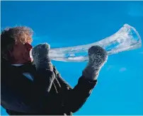  ??  ?? TESTING TIME: Musician Terje Lsungset tests a musical instrument made of ice outside his workshop in Finse
