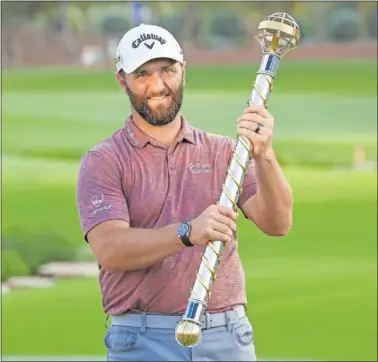  ?? ?? Jon Rahm recibe el trofeo que le acredita como ganador del DP World Tour Championsh­ip.