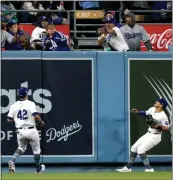  ?? HARRY HOW — GETTY IMAGES ?? Chris Taylor, left, and Kiké Hernández watch a three-run homer by the Nationals' Luis Garcia Jr. in the fifth inning of Monday night's game at Dodger Stadium.