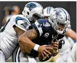  ?? DAVID T. FOSTER III / CHARLOTTE OBSERVER ?? Cowboys quarterbac­k Dak Prescott was sacked six times and had a hard time finding receivers against the Panthers during the opener.