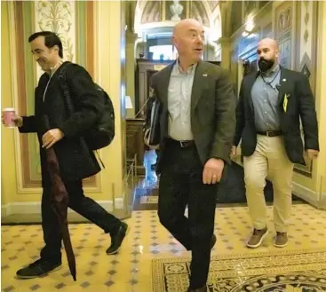  ?? MARK SCHIEFELBE­IN/AP ?? Homeland Security Secretary Alejandro Mayorkas, center, arrives for border security talks Sunday.