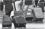  ?? Brian Mcdermott / Associated Press file ?? Baggage fees hit a record $1.3 billion in the first three months of the year, according to federal data.