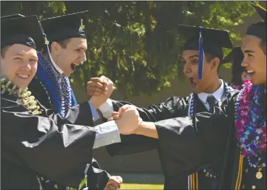  ??  ?? Above: Lodi Academy graduates have some last fun on the school grounds following their commenceme­nt ceremony on Sunday. Right: Rami Abu-Ramadan walks down a confetti covered path at the end of the Lodi Academy commenceme­nt ceremony.