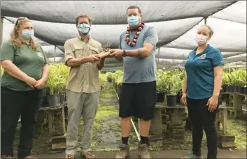  ?? MISC photo ?? 2020 recipient Mark Mark Blietz (center), owner of Northshore Tropicals, is presented with the Malama i ka Aina Award by Adam Radford of the Maui Invasive Species Committee during a small ceremony at the Haiku nursery. The award recognizes the proactive efforts of those working within the landscape community to address the threat of invasive species. Maui County representa­tive Makale‘a Ane (right) and Maui Associatio­n of Landscape Profession­al rep Allison Wright (left) were present during the ceremony.