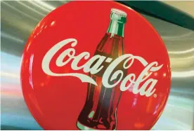  ??  ?? This file photo taken on May 1, 2016 shows a Coca-Cola logo in a restaurant in Washington, DC. — AFP