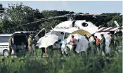  ??  ?? Children offer prayers of thanks as their teacher breaks the news of more rescues in the cave not far from their school in Chiang Rai. Meanwhile, a helicopter takes on board another survivor