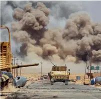  ?? AFP ?? Smoke billows as Iraqi forces advance towards Al Ayadieh village, during an operation to retake the city from the Daesh. —