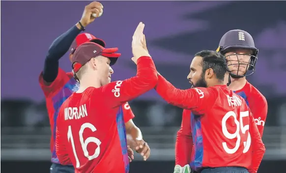  ?? EPA ?? England captain Eoin Morgan, left, and Adil Rashid celebrate during their win over Australia in the group stage of the T20 World Cup in Dubai
