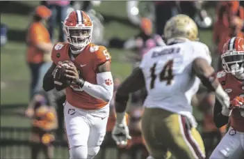  ?? ASSOCIATED PRESS ?? CLEMSON QUARTERBAC­K D.J. UIAGALELEI (5) passes the ball during the first half a game against Boston College on Saturday in Clemson, S.C.