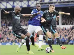  ?? — AP ?? LIVERPOOL: Everton’s Romelu Lukaku, center, battles for the ball with West Bromwich Albion’s Allan Nyom, left, and Gareth McAuley during the English Premier League soccer match at Goodison Park, Liverpool, England, yesterday.