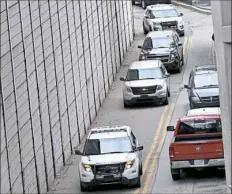  ?? Matt Freed/Post-Gazette ?? Police escort two SUVs Monday to the Allegheny County Jail. Robert Bowers, the accused gunman in the shooting at Tree of Life Synagogue, was arraigned earlier in the day at the federal courthouse in Downtown.