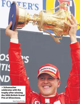  ?? Nick Potts/PA Wire. ?? Schumacher celebrates with the trophy after winning the 2004 British Grand Prix at Silverston­e.