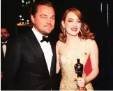  ??  ?? Actor Leonardo DiCaprio (left) and actress Emma Stone, winner of Best Actress for ‘La La Land’ pose backstage.