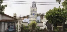  ?? AP photo ?? A replica of a leaning Tower of Pisa constructe­d by artist and architect Rubén Díaz, adorns a private garden in Ituzaingo, Argentina, Oct. 15. Replicas of several European masterwork­s in the municipali­ty were carried out by Díaz, who is considered a “generator of fantasies.” Díaz’s goal is in part to let his neighbors “travel” to places they would normally never see.