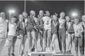  ?? KYLE BUMPERS Special to the Miami Herald ?? The Palmer Trinity girls’ track and field team celebrates after finishing as state runners-up on Wednesday night.