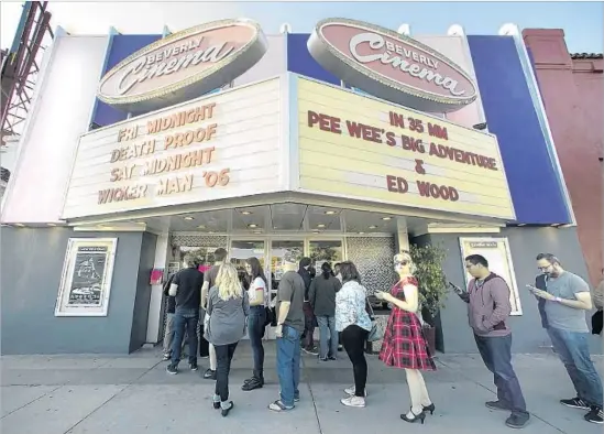  ?? Photograph­s by Calvin B. Alagot Los Angeles Times ?? PATRONS queue up at the New Beverly Cinema, where double features of classic, indie, cult and foreign flicks are screened each night — and all on 35-mm film.