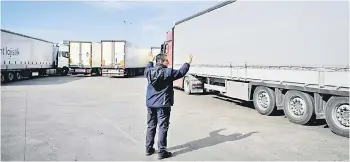  ?? ?? A Bulgarian customs officer waves to a truck driver at Kapitan Andreevo border checkpoint.