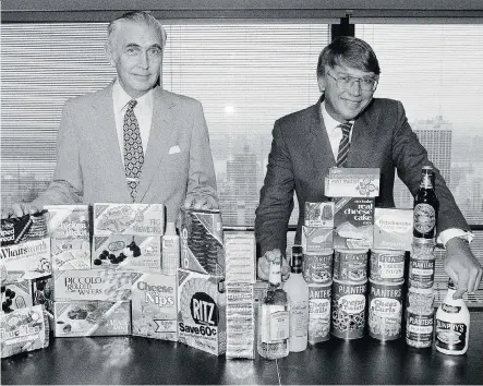  ?? THE NEW YORK TIMES FILES ?? Frederick Ross Johnson, right, then-president of Standard Brands, and Robert Schaeberle, then-chairman of Nabisco, are pictured after the two companies had merged to become Nabisco Brands in 1981. Johnson later took over as CEO in 1987 when Schaeberle...