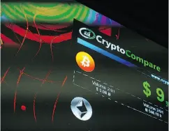  ?? MARY TURNER / BLOOMBERG ?? The symbols of Bitcoin and Ethereum cryptocurr­encies are displayed on a screen at the Crypto Investor Show in London on Saturday