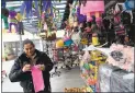  ?? JANE TYSKA — STAFF PHOTOGRAPH­ER ?? Mario Rosario works at her shop in the Fruitvale Public Market.