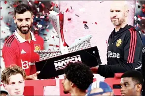  ?? (Pic: Daily Mail) ?? It was a dream start for Erik ten Hag (R) as the Manchester United boss lifted ‘The Match’ trophy with Bruno Fernandes after yesterday’s game.