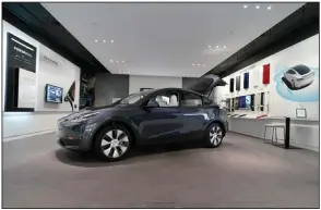  ?? (AP File) ?? A Tesla Model Y Long Range is on display in 2021 at a Tesla Gallery in Troy, Mich. Tesla Inc. on Wednesday posted record fourth-quarter and full-year earnings as deliveries of its electric vehicles rose despite a shortage of computer chips.