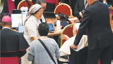  ?? GREGORIO BORGIA AP ?? Pope Francis is greeted by female participan­ts of the opening session of the 16th General Assembly of the Synod of Bishops as he arrives in the Paul VI Hall at the Vatican on Wednesday. The synod is the Catholic Church’s first to allow laypeople and women to vote.