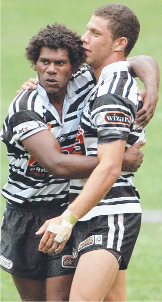  ??  ?? Shannon Walker and James Wood (right) celebrate that memorable grand final win in 2007. CONNOR O’BRIEN