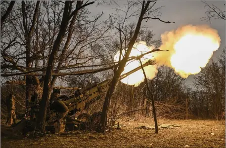  ?? PHOTO BY ARIS MESSINIS/AFP VIA GETTY IMAGES ?? Ukrainian servicemen fire a M777 howitzer at Russian positions near Bakhmut, eastern Ukraine, on March 17, 2023, amid the Russian invasion of Ukraine.