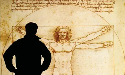  ??  ?? A person looks at an electronic display of The Vitruvian Man 1490, a drawing by Leonardo da Vinci. Photograph: Alamy Stock Photo