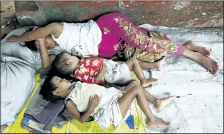  ?? REUTERS ?? A pregnant mother and her children sleep at a monastery in this file photo. Myanmar has passed a new law that forces some women to have children at least three years apart.