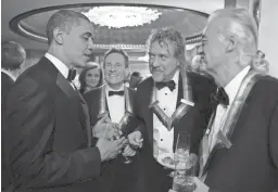  ?? THE WHITE HOUSE/GETTY IMAGES ?? U.S. President Barack Obama talks with the surviving members of Led Zeppelin John Paul Jones, Robert Plant and Jimmy Page during intermissi­on at the Kennedy Center Honors on Dec. 12, 2012, in Washington, D.C.